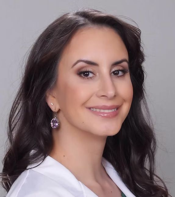 Elizabeth Slauter, M.D. smiling in a white coat