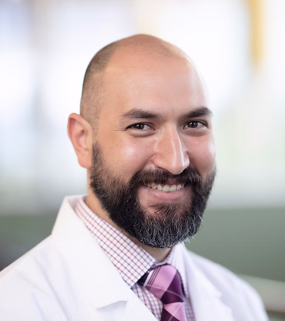 Kevin Hodnett, M.D. smiling in a white coat